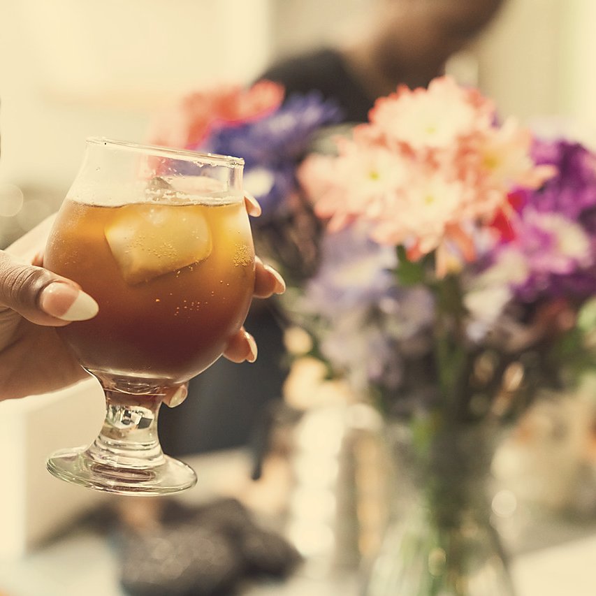 Cold brew rising from cup in hand